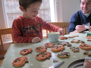 kids baking decorating halloween cookies