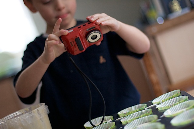 Children food blogging taking photos of baking