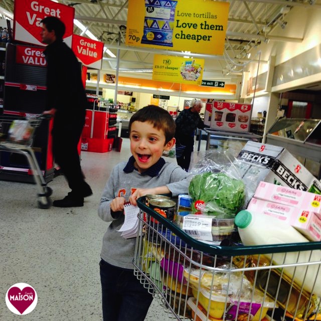 Morrisons trolley full of groceries with six year old