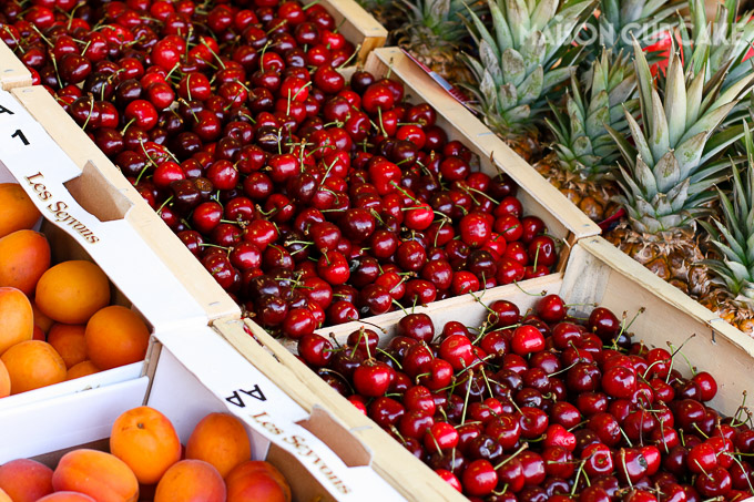 Close up of cherries and fruit for sale at French market stall