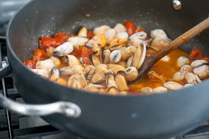 Cooking mussels and mini plum tomatoes