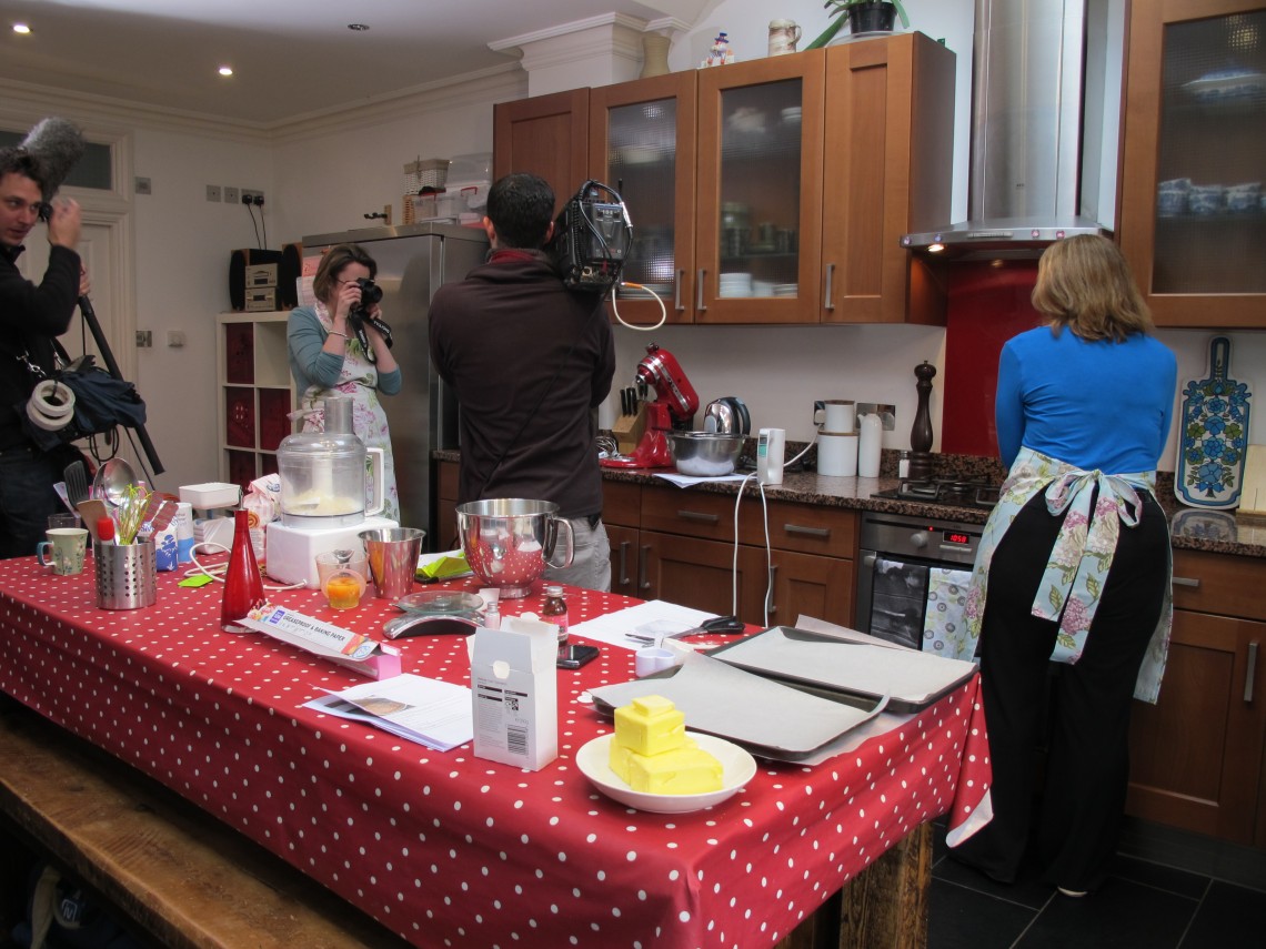 TV camera man filming in a kitchen