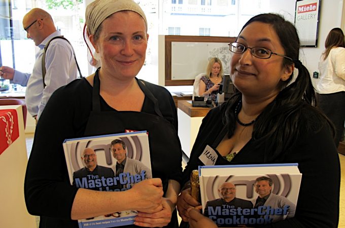 Two ladies holding Masterchef books with Gregg Wallace behind them