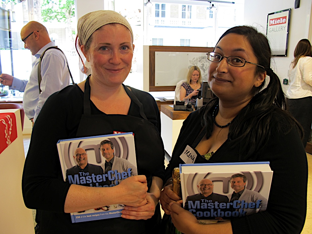 Two ladies holding Masterchef books with Gregg Wallace behind them