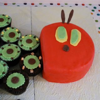 A cake depicting the head of The Very Hungry Caterpillar