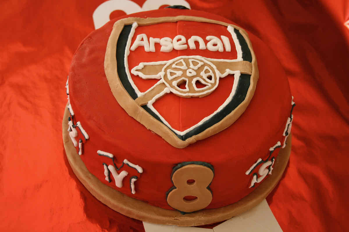 Red sugar paste covered cake decorated with the Arsenal Football team badge.