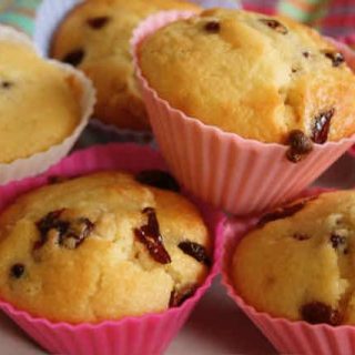 White Chocolate Cherry Muffins: A pile of muffins in pink silicon cases