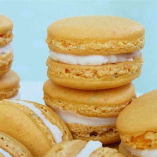 Lemon Macarons with Rosemary recipe - yellow macarons stacked in piles