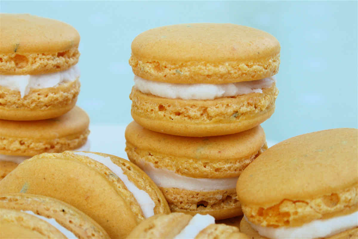 Lemon Macarons with Rosemary recipe - yellow macarons stacked in piles