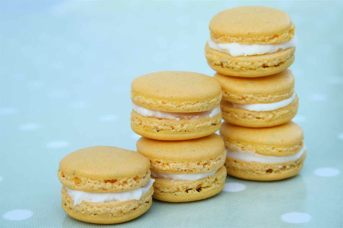 Lemon Macarons with Rosemary recipe - yellow macarons stacked in piles of 1, 2, 3