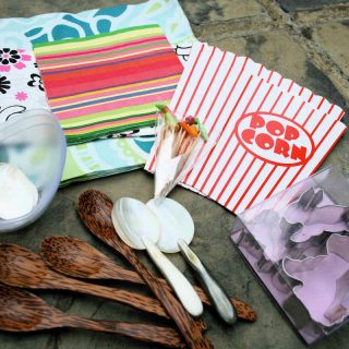 Selection of spoons, napkins, flat popcorn boxes and cocktail sticks; props for food styling