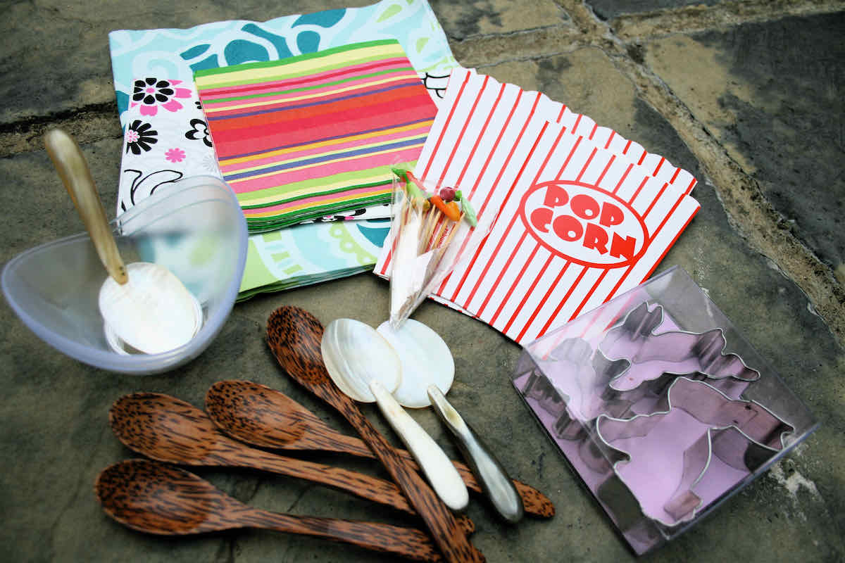 Selection of spoons, napkins, flat popcorn boxes and cocktail sticks; props for food styling