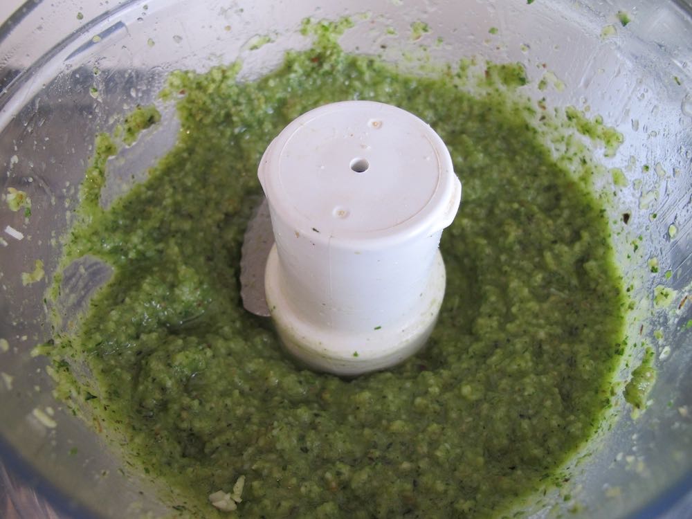 Bright green cobnut pesto in food processor bowl