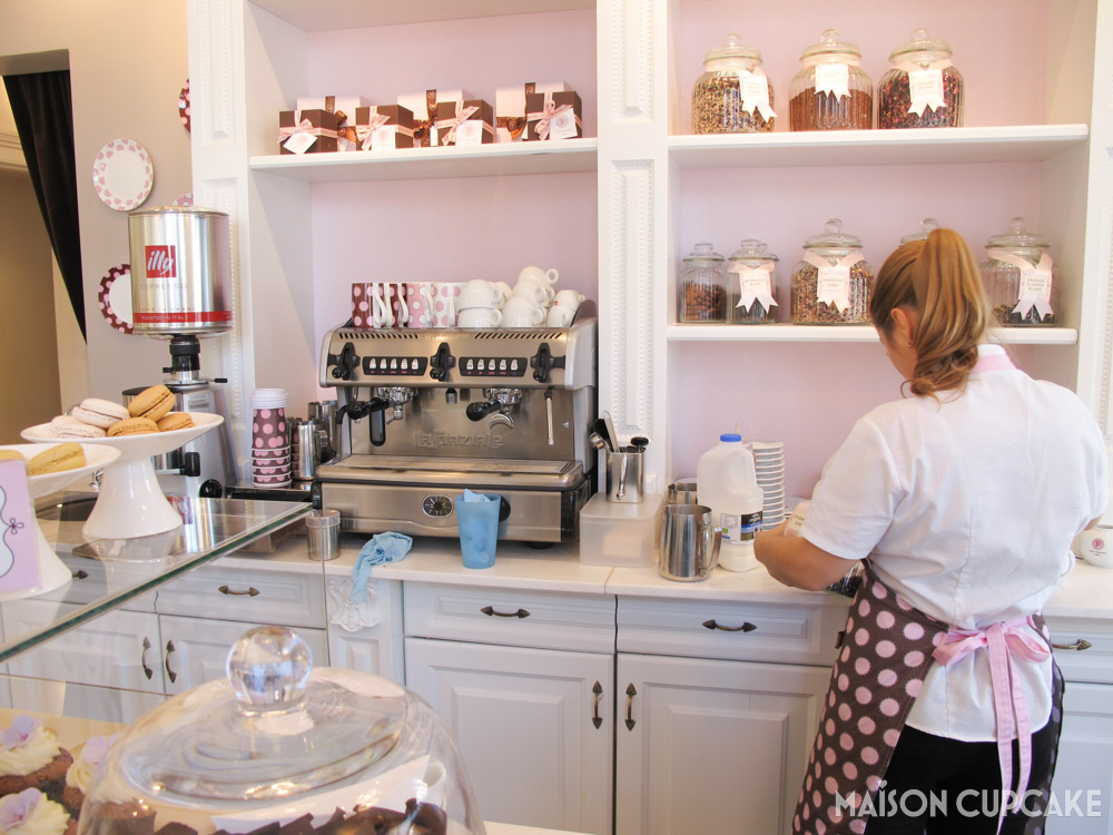 Peggy Porschen Parlour Cafe London Belgravia - counter with coffee machine and rear view of server