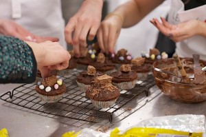 Leith's Cookery School Easter Baking Class: hands decorating chocolate cakes