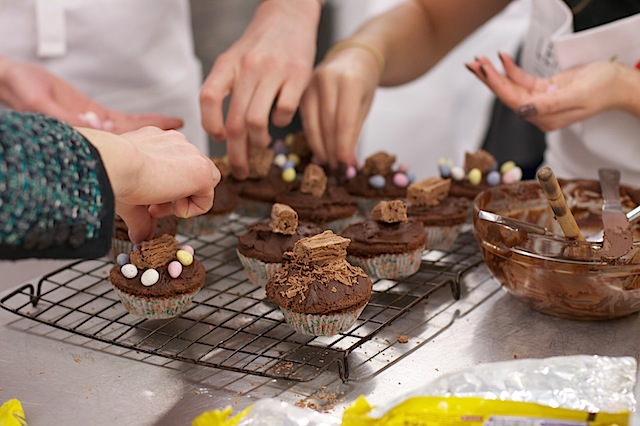 Leith's Cookery School Easter Baking Class: hands decorating chocolate cakes