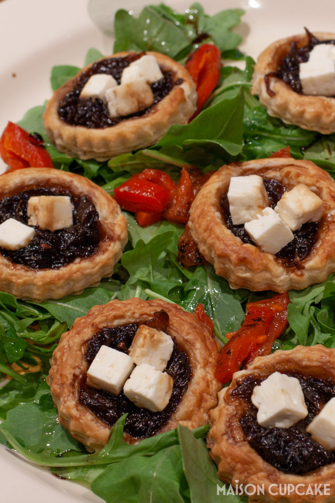Red Onion Tarts With Feta on bed of rocket - portrait