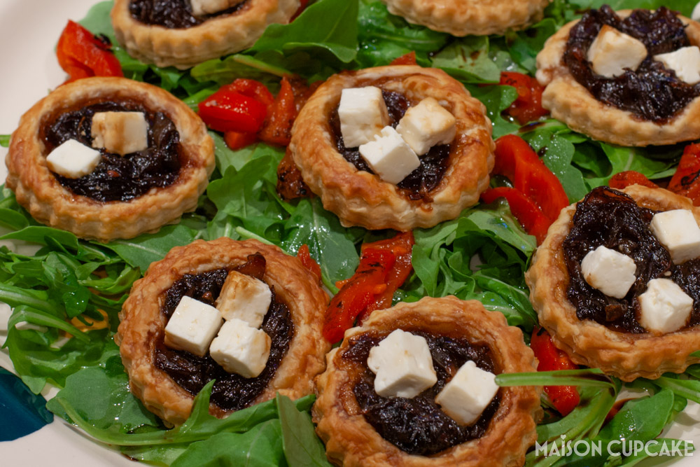 Red Onion Tarts With Feta on bed of rocket - close up landscape