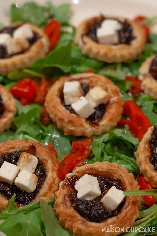 Red Onion Tarts With Feta on bed of rocket - close up portrait
