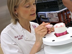 Mich Turner Little Venice Cake Company piping a miniature cake