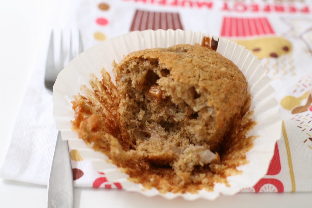 Banana Fudge Muffin torn open to show texture with gooey fudge pieces