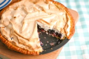Cherry Meringue Pie, close up landscape with slice cut away showing fruit filling