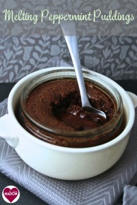 Mint Chocolate Puddings with After Eight - served in glass ramekins set inside larger white dish. A spoon is dipped into the gooey melting centre.