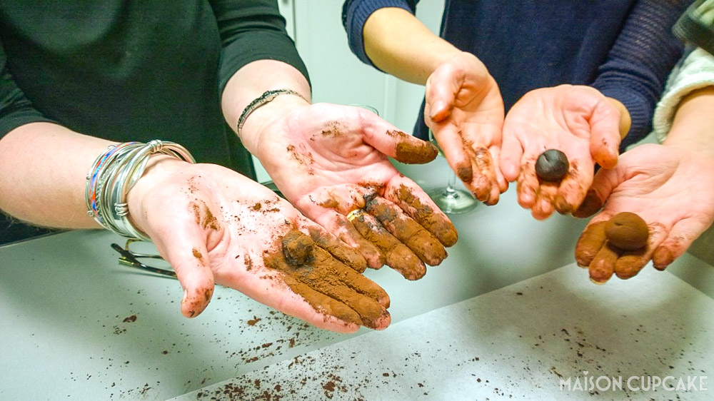 Cocoa covered hands rolling truffles at Chocolate Truffle Making Workshop with Paul A Young