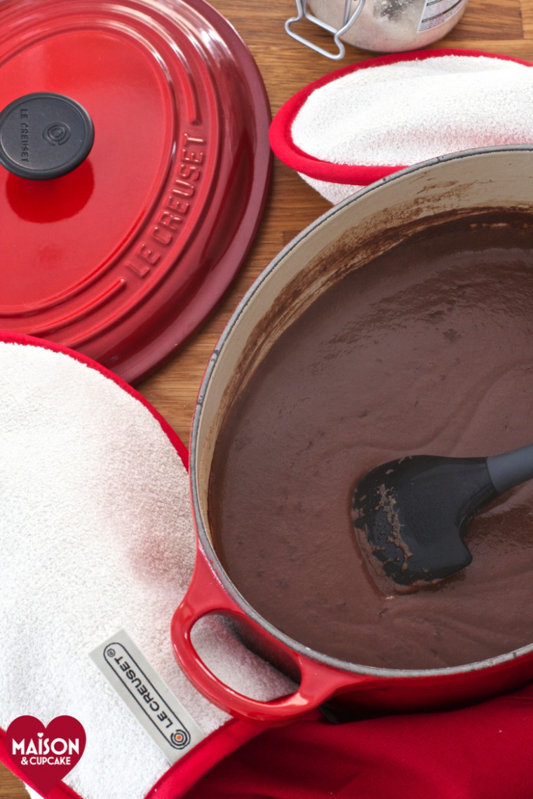 Nutella chocolate semolina, seen from above, being stirred in a red Le Creuset casserole dish.