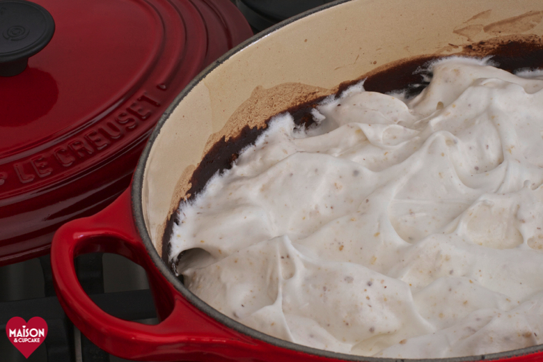 Steps to make Nutella chocolate semolina pudding with hazelnut meringue; fluffy raw meringue is covering the semolina in a red casserole dish before being baked.