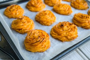 Duchess Potatoes with Sun-Dried Tomatoes - Piped Swirls of Golden Potato on a baking tray