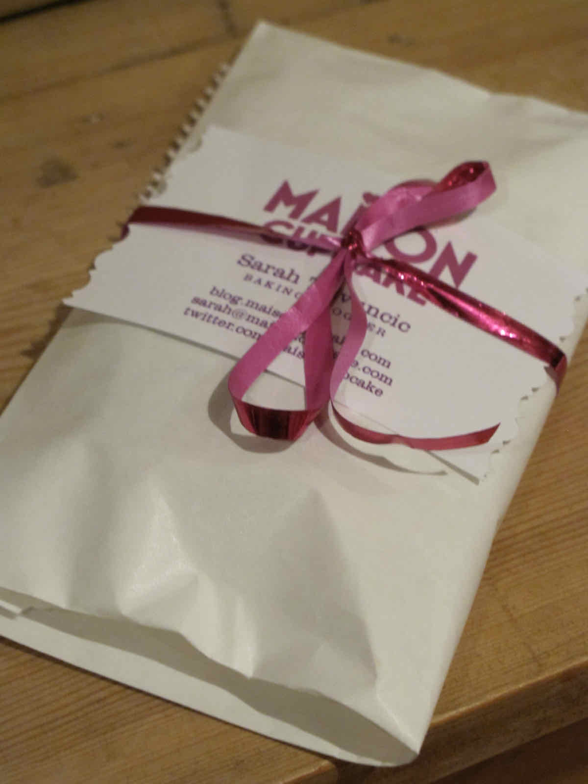 Small white packed wrapped with pink ribbon.