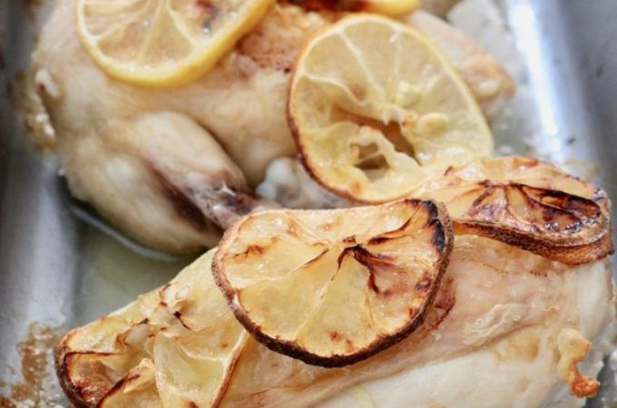 Oven dish with three chicken supreme pieces with lemon slices - portrait layout