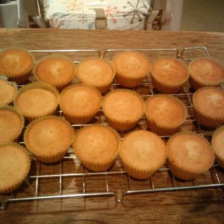 A batch of plain cupcakes on a wire cooling tray