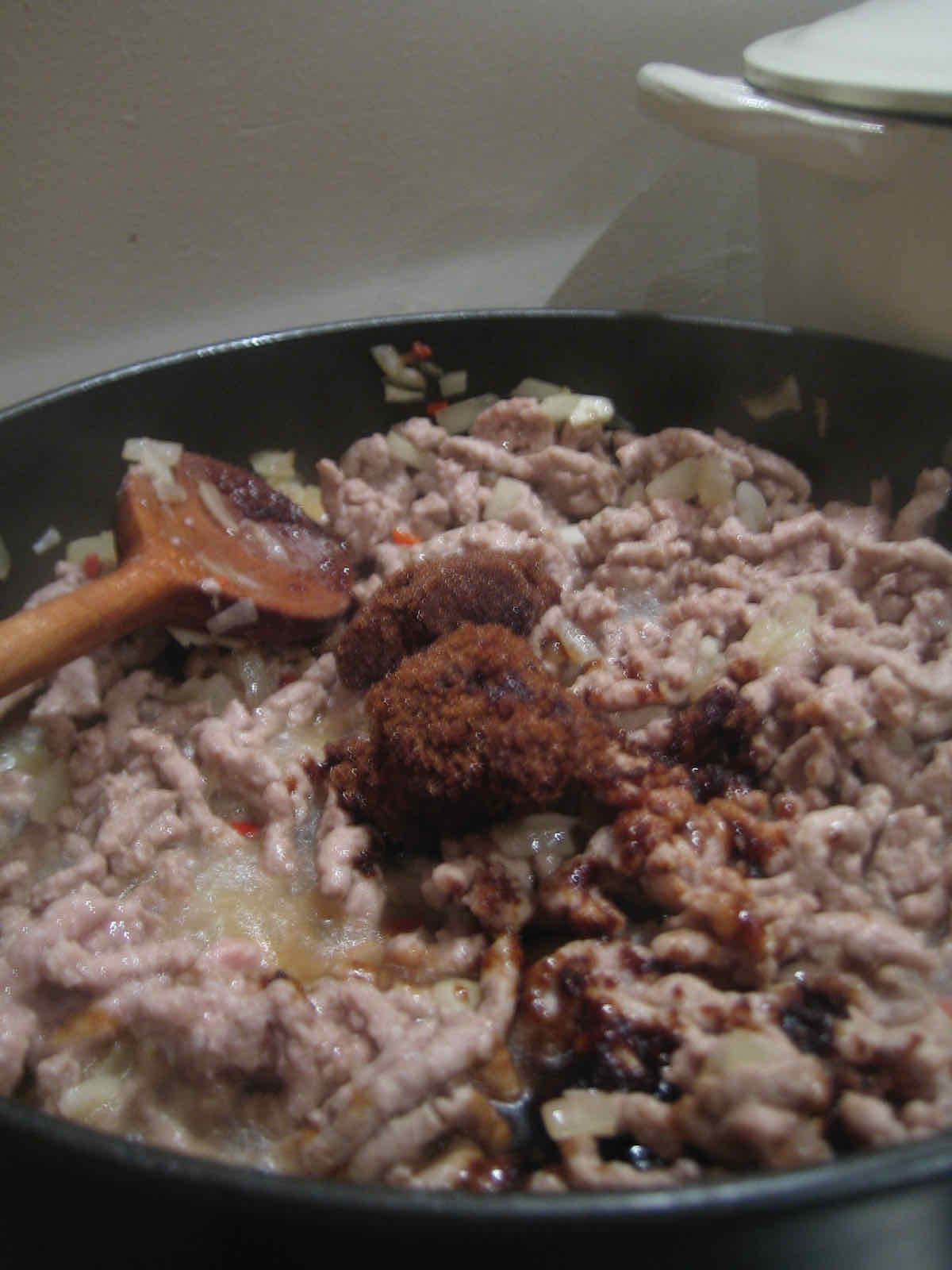 Minced pork meat being fried in a pan