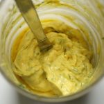Bright yellow mayonnaise with flecks of dill