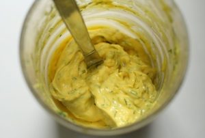 Bright yellow mayonnaise with flecks of dill