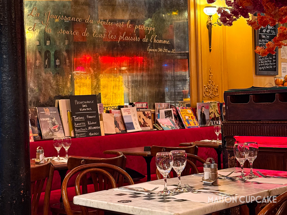 Warm red bistro interior with mirror, in Paris.