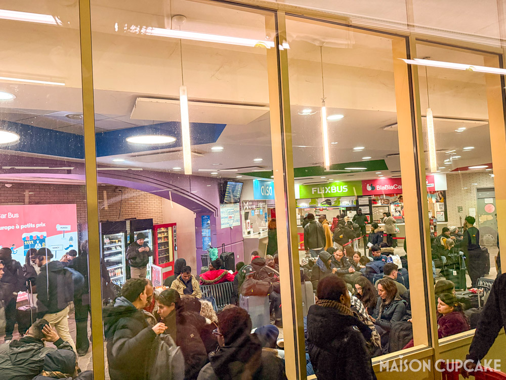 Busy waiting room filled with passengers at Bercy coach station Paris.