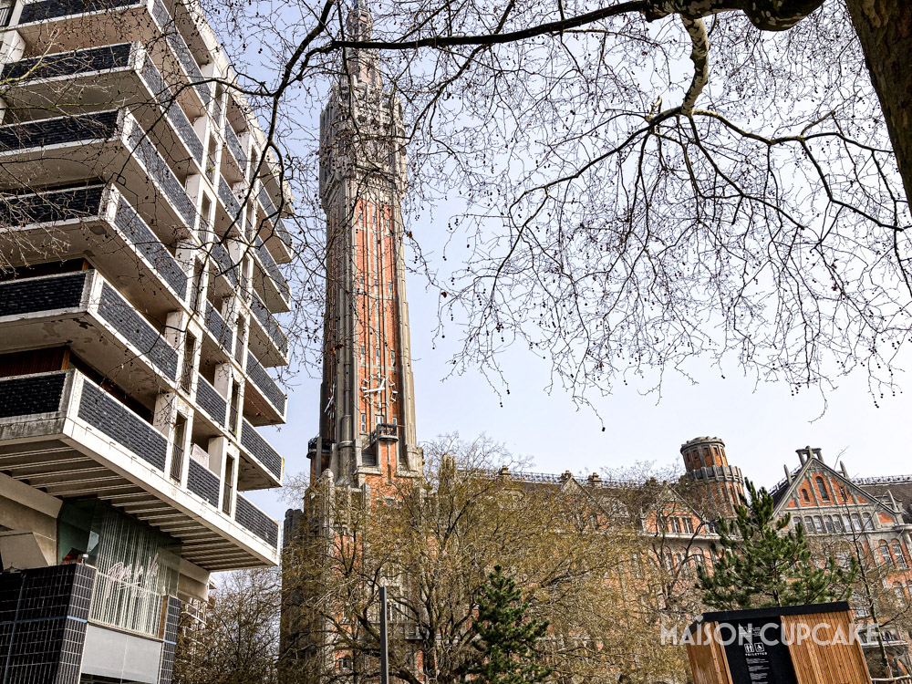 Brutalist apartment building with Lille gothic red brick Belfry tower.