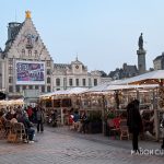 Lille Grand Place at dusk with cafes and Flemish buildings