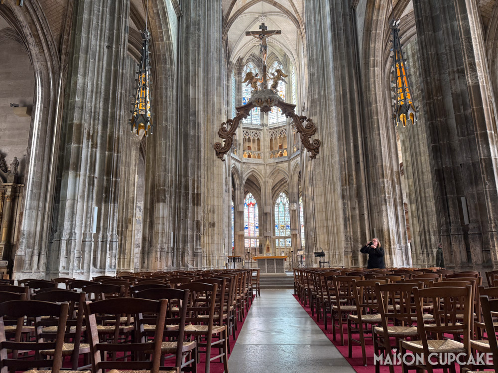 Interior view of nave and vaulted ceiling and crucifix inside Eglise Saint Maclou in Rouen, Normandy