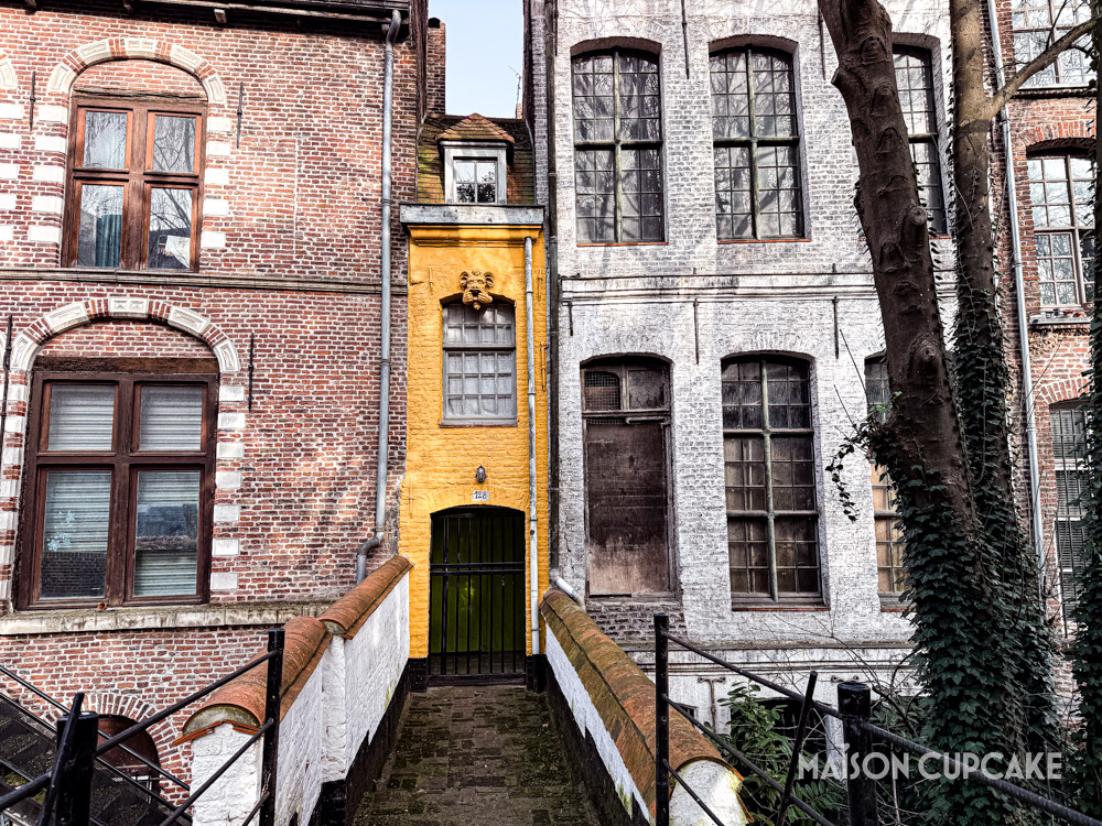 Narrow yellow building known as the smallest house in Lille