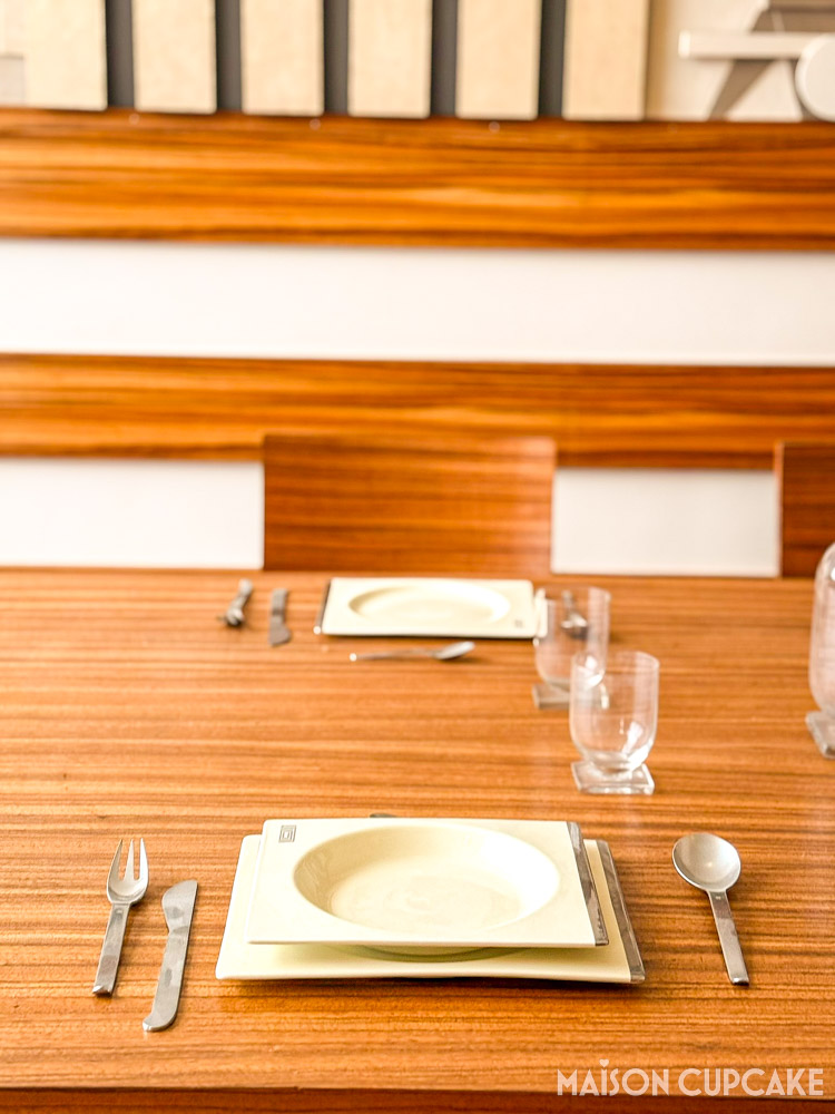 Warm toned wood interior with Art Deco square shaped place settings at Villa Cavrois restored modernist home France