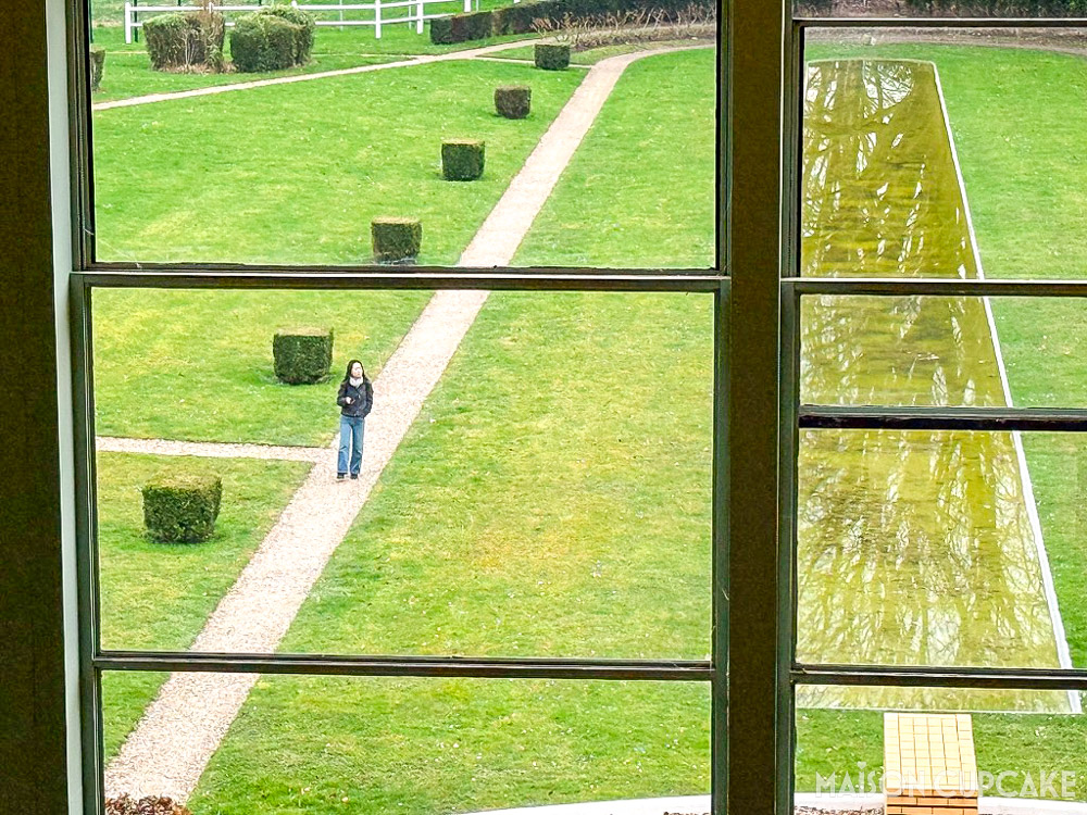Art Deco window frames at Villa Cavrois overlooking landscaped modernist garden and water feature