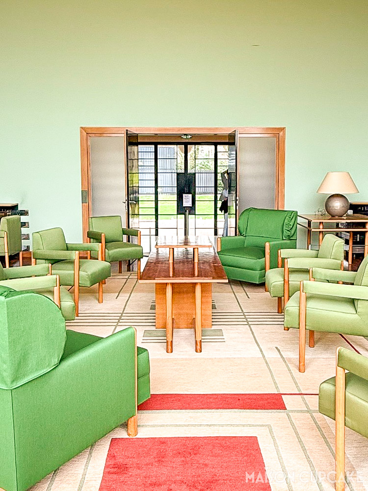 Interior of Villa Cavrois salon with strong geometry and green minimalist chairs